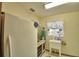 Bright laundry area with white tiled floors, a utility sink, refrigerator, and window at 151 W Hamlin Trl, Frostproof, FL 33843