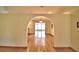 Open living room featuring hardwood floors and an archway leading to another room at 151 W Hamlin Trl, Frostproof, FL 33843