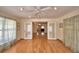 Spacious living room showcasing hardwood floors, recessed lighting, windows, and French doors at 151 W Hamlin Trl, Frostproof, FL 33843