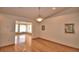 A bright living room with hardwood floors and natural light streaming from the adjacent sunroom at 151 W Hamlin Trl, Frostproof, FL 33843