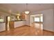 An open living space featuring hardwood floors, recessed lights and open access to the kitchen at 151 W Hamlin Trl, Frostproof, FL 33843
