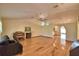 Spacious living room featuring hardwood floors, a ceiling fan, and an arched doorway at 151 W Hamlin Trl, Frostproof, FL 33843