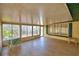 Enclosed patio with tiled flooring, bright windows, and comfortable seating at 151 W Hamlin Trl, Frostproof, FL 33843