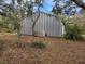 Exterior view of the large silver Quonset hut with attached A/C unit at 151 W Hamlin Trl, Frostproof, FL 33843