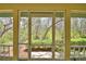 View of the lush greenery from the home's screened in porch at 151 W Hamlin Trl, Frostproof, FL 33843