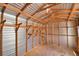 Inside the shed, find a metal interior with wooden supports and shelves for organized storage solutions at 151 W Hamlin Trl, Frostproof, FL 33843