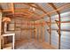 Shed interior featuring wooden beams, shelves and an air conditioning unit at 151 W Hamlin Trl, Frostproof, FL 33843