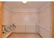 Spacious walk-in closet with ample white shelving and hanging space at 151 W Hamlin Trl, Frostproof, FL 33843