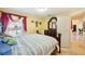 Bright bedroom with bed, large ornate wood mirror on dresser, and marble flooring at 1621 Normandy Heights Blvd, Winter Haven, FL 33880