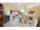 Living room featuring sliding glass doors to the pool and a comfortable leather sectional at 1621 Normandy Heights Blvd, Winter Haven, FL 33880