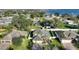 Aerial view of a two story home with mature trees and a serene community lake in background at 1904 Eloise Cove Dr, Winter Haven, FL 33884