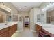 Well-lit bathroom with double sinks, walk-in shower, and tiled floors at 1904 Eloise Cove Dr, Winter Haven, FL 33884