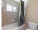 Clean bathroom with tile surround tub/shower and a frosted window at 1904 Eloise Cove Dr, Winter Haven, FL 33884