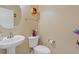Powder room featuring pedestal sink, toilet, and decorative shelving for a functional space at 1904 Eloise Cove Dr, Winter Haven, FL 33884