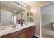 Lovely bathroom features dual sinks, wood cabinets, and plenty of light at 1904 Eloise Cove Dr, Winter Haven, FL 33884