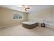 Bedroom features a window, ceiling fan and neutral carpet at 1904 Eloise Cove Dr, Winter Haven, FL 33884