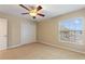Bedroom with a ceiling fan, closet, and view to the street at 1904 Eloise Cove Dr, Winter Haven, FL 33884
