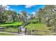 Picturesque wooden walkway winds through lush greenery and offers a view of lake at 1904 Eloise Cove Dr, Winter Haven, FL 33884