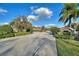 Stone community sign along paved road, featuring mature landscaping and stone entrance features at 1904 Eloise Cove Dr, Winter Haven, FL 33884