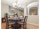 Cozy dining room featuring a round wood table and a stylish chandelier at 1904 Eloise Cove Dr, Winter Haven, FL 33884