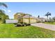 Home with a 3 car garage, lush landscaping, and a paver driveway at 1904 Eloise Cove Dr, Winter Haven, FL 33884