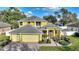 Charming two-story home with a well-manicured lawn and a three car garage and walkway to front door at 1904 Eloise Cove Dr, Winter Haven, FL 33884