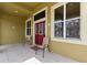 Inviting front porch with tile flooring, comfortable seating, and decorative front door at 1904 Eloise Cove Dr, Winter Haven, FL 33884