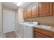 Laundry room featuring front load washer and dryer, cabinets, countertop and sink at 1904 Eloise Cove Dr, Winter Haven, FL 33884