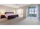 Serene main bedroom with slider to screened-in porch overlooking a backyard at 1904 Eloise Cove Dr, Winter Haven, FL 33884