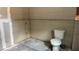 Unfinished bathroom with exposed drywall and a toilet overlooking the yard at 1928 Old Apopka Rd, Apopka, FL 32703