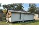 Damaged exterior of unfinished home with partial siding and roof repairs evident in rural setting at 1928 Old Apopka Rd, Apopka, FL 32703