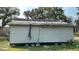 Damaged exterior of unfinished home with partial siding and roof repairs evident at 1928 Old Apopka Rd, Apopka, FL 32703