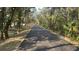 Scenic paved walking path surrounded by lush trees and natural landscape, perfect for outdoor activities at 1928 Old Apopka Rd, Apopka, FL 32703