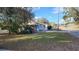 Exterior view of a cozy home with a spacious, green lawn at 201 Dr J A Wiltshire W Ave, Lake Wales, FL 33853