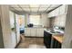 Functional kitchen with white cabinets and a black electric stove at 201 Dr J A Wiltshire W Ave, Lake Wales, FL 33853
