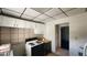 Functional kitchen with white cabinets and a black electric stove at 201 Dr J A Wiltshire W Ave, Lake Wales, FL 33853