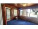 Bright sunroom featuring wood walls, carpeted floors, and lots of natural light at 201 Dr J A Wiltshire W Ave, Lake Wales, FL 33853
