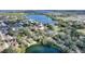 Expansive aerial view of the lakeside neighborhood showcasing lush landscapes and tranquil waterfronts at 208 Country Ne Ln # 208, Winter Haven, FL 33881