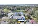 Aerial shot of condominium complex, highlighting the surrounding greenery and pond at 208 Country Ne Ln # 208, Winter Haven, FL 33881