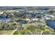 Breathtaking aerial view of lakeside homes with lush landscaping surrounded by verdant trees at 208 Country Ne Ln # 208, Winter Haven, FL 33881