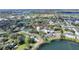 Serene aerial shot of lakeside neighborhood showcasing lush landscaping and homes near the water at 208 Country Ne Ln # 208, Winter Haven, FL 33881