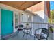 Cozy balcony with seating area and a bright turquoise front door, perfect for relaxing outdoors at 208 Country Ne Ln # 208, Winter Haven, FL 33881