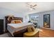 Bedroom featuring a large bed, bedside bench, and sunny windows at 208 Country Ne Ln # 208, Winter Haven, FL 33881