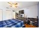 Bright bedroom with hardwood floors, ceiling fan, closet and a TV at 208 Country Ne Ln # 208, Winter Haven, FL 33881