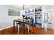 Dining area featuring hardwood floors, modern lighting, and space for entertaining at 208 Country Ne Ln # 208, Winter Haven, FL 33881