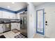 Galley kitchen with stainless steel appliances, white cabinets, and bright natural light at 208 Country Ne Ln # 208, Winter Haven, FL 33881