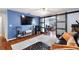 Comfortable living room with hardwood floors, TV, couch, and sliding glass doors to another room at 208 Country Ne Ln # 208, Winter Haven, FL 33881