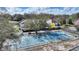 Overhead view of a tennis court with nearby condominiums and surrounding greenery at 208 Country Ne Ln # 208, Winter Haven, FL 33881