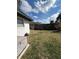 Lawn backyard with chain link and wood fence, and white block construction building at 229 Durrell Rd, Winter Haven, FL 33884