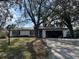 Charming single-story home featuring a well-maintained front yard and mature trees at 229 Durrell Rd, Winter Haven, FL 33884